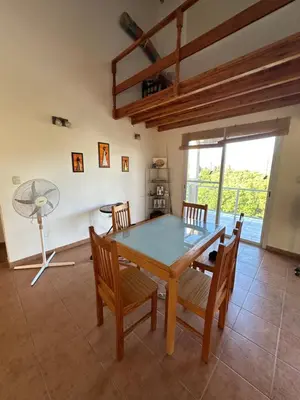 a dining room with a table and chairs and a fan at Casa Siquiman in Villa Parque Siquiman