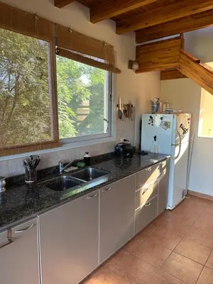a kitchen with a sink and a refrigerator at Casa Siquiman in Villa Parque Siquiman