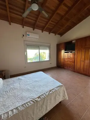 a bedroom with a large bed and a window at Casa Siquiman in Villa Parque Siquiman