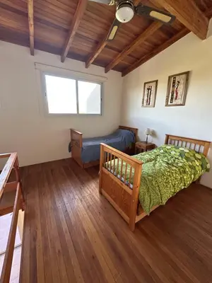 a bedroom with a bed and a couch at Casa Siquiman in Villa Parque Siquiman