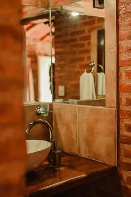 a bathroom with a sink and a mirror at Cabañas Achikilla in Las Calles