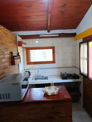 a small kitchen with a sink and a stove at Cabaña villa ediht in Villa Parque Siquiman