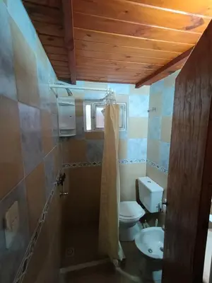 a bathroom with a toilet and a sink at Cabaña villa ediht in Villa Parque Siquiman