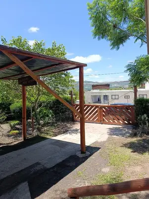 a wooden pergola with a wooden fence at Cabaña villa ediht in Villa Parque Siquiman