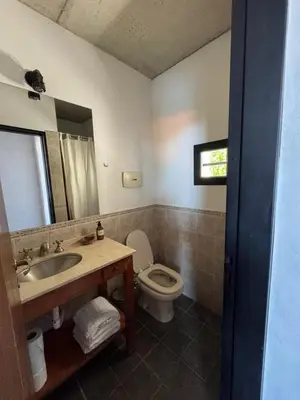 a bathroom with a sink and a toilet at Casa de diseño en Costa Azul in Villa Carlos Paz