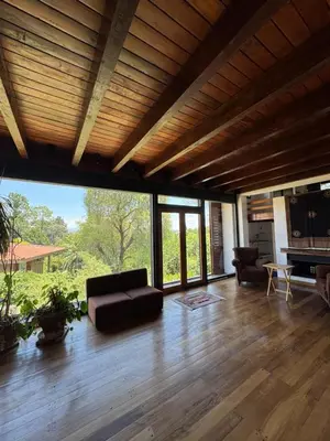 a living room with a couch and a fireplace at Casa de diseño en Costa Azul in Villa Carlos Paz