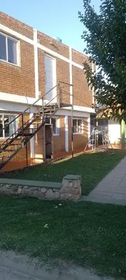 a brick building with a staircase in front of it at Bella Fefi in Villa Cura Brochero