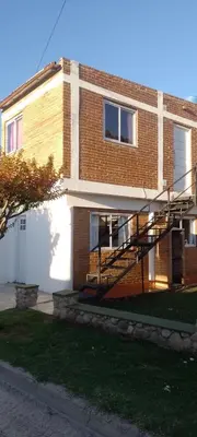 a brick building with a staircase on the side of it at Bella Fefi in Villa Cura Brochero