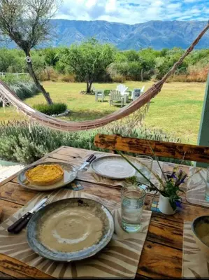 a table with plates of food on top of it at Complejo El Caldén in Merlo
