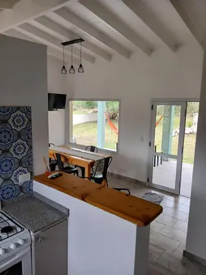 a kitchen with a wooden counter top in a room at Complejo El Caldén in Merlo