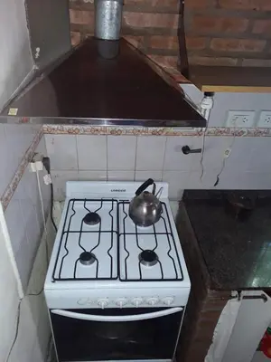 a tea kettle sitting on top of a stove in a kitchen at Solares LOFT in Mina Clavero