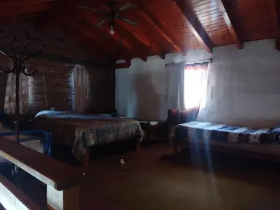 a bedroom with two beds and a window in a room at Solares LOFT in Mina Clavero
