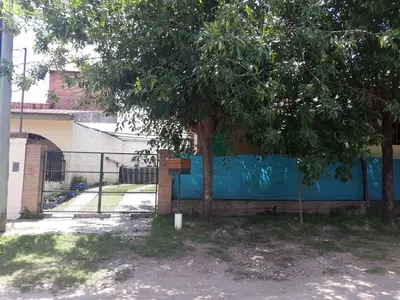 a tree in front of a blue fence at Solares LOFT in Mina Clavero