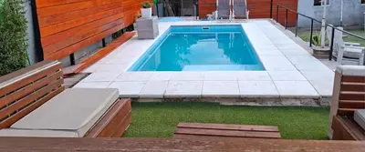 a swimming pool in the backyard of a house at Apartamento Jhaky 2 in Villa Carlos Paz