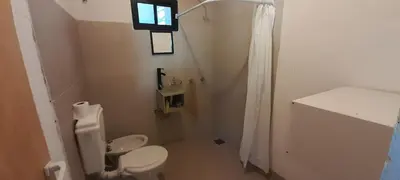a white bathroom with a toilet and a window at Apartamento Jhaky 2 in Villa Carlos Paz