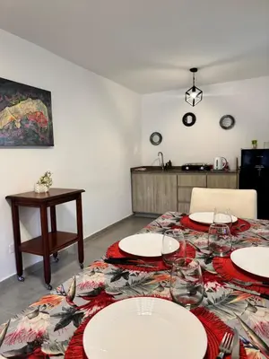 a room with a table with white plates on it at Moderno dpto zona norte 1 dorm in Cordoba