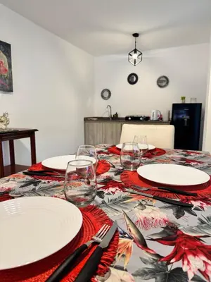 a table with plates and wine glasses on it at Moderno dpto zona norte 1 dorm in Cordoba