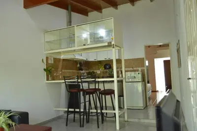 a kitchen with a bar with stools in it at Arturo in Cordoba