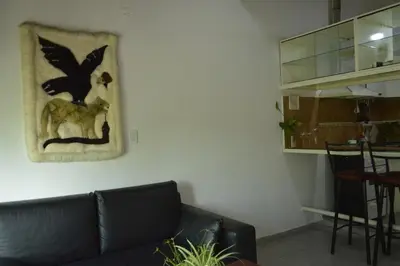 a living room with a couch and a picture of a bird at Arturo in Cordoba