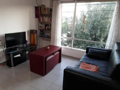 a living room with a couch and a large window at Arturo in Cordoba