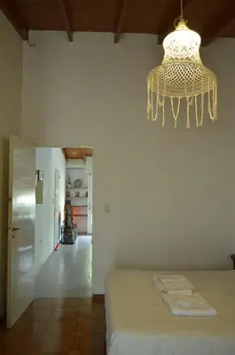 a chandelier hanging over a bed in a room at Arturo in Cordoba