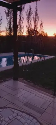 a swing hanging from a tree next to a pool at Lo de Nor - Refugio de Montaña in San Antonio de Arredondo