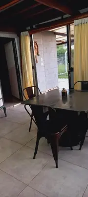 a ping pong table in a room with a dog in the background at Lo de Nor - Refugio de Montaña in San Antonio de Arredondo