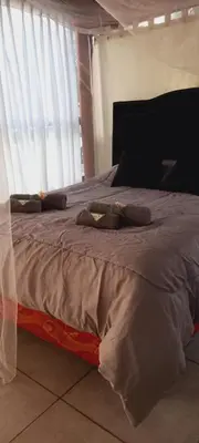 a bed with two pillows on it in a bedroom at Lo de Nor - Refugio de Montaña in San Antonio de Arredondo