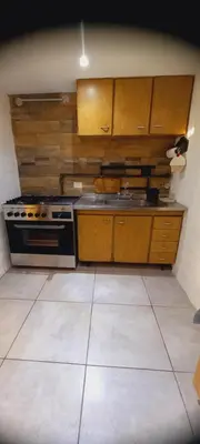a kitchen with a stove and a sink at Lo de Nor - Refugio de Montaña in San Antonio de Arredondo