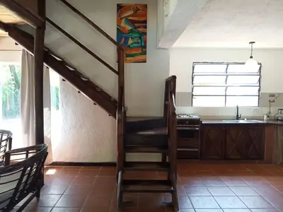 a room with a staircase in a kitchen at Casa con piscina privada en las sierras de Córdoba in Villa Anizacate