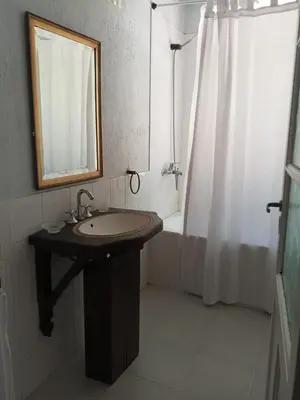 a bathroom with a sink and a mirror and a shower at Casa con piscina privada en las sierras de Córdoba in Villa Anizacate