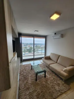 a living room with a couch and a glass table at Civis Tower Excepcional Departamento in Villa Carlos Paz