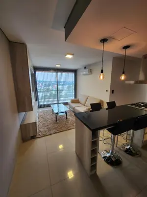 a kitchen and living room with a couch and a table at Civis Tower Excepcional Departamento in Villa Carlos Paz