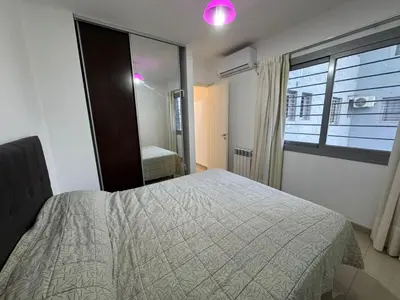 a bedroom with a bed and a window at Myng Departamento en el centro de Carlos Paz in Villa Carlos Paz