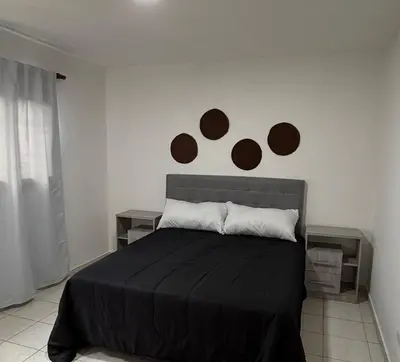 a bedroom with a bed with brown circles on the wall at Departamento PA in Villa Carlos Paz