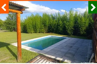 a swimming pool in the backyard of a house at Cabaña Habibi in Potrero de Garay