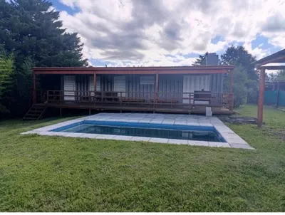 a house with a swimming pool in the yard at Cabaña Habibi in Potrero de Garay