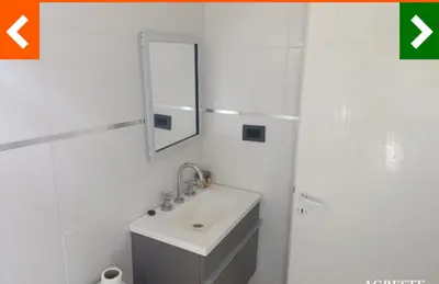a white bathroom with a sink and a mirror at Cabaña Habibi in Potrero de Garay