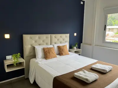 a bedroom with a large bed with two towels on it at Astoria Hotel in Villa Carlos Paz