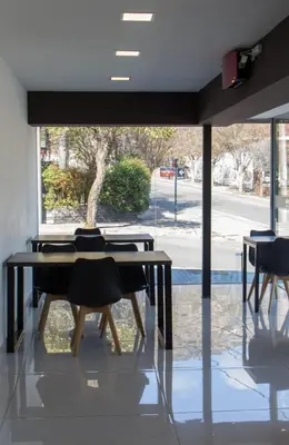 a table and chairs in a room with a window at Astoria Hotel in Villa Carlos Paz