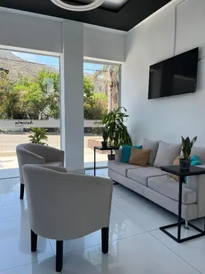 a living room with a couch and a tv at Astoria Hotel in Villa Carlos Paz