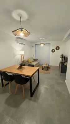 a living room with a table and a couch at New Modern Apartment Ciudad Gamma Cordoba Luxury in Cordoba