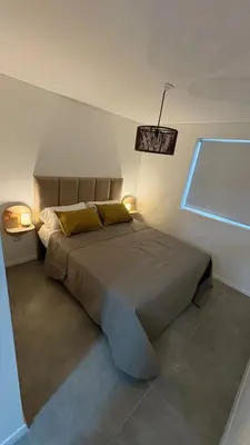 a bedroom with a bed with two lamps and a window at New Modern Apartment Ciudad Gamma Cordoba Luxury in Cordoba