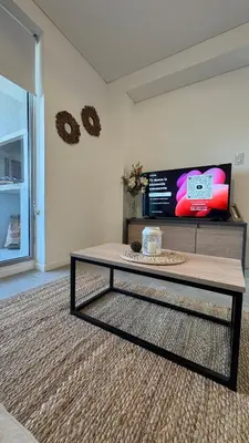 a coffee table in a living room with a tv at New Modern Apartment Ciudad Gamma Cordoba Luxury in Cordoba
