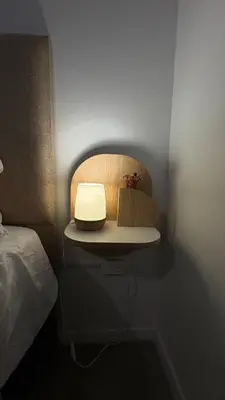 a room with a bed and a table with a lamp at New Modern Apartment Ciudad Gamma Cordoba Luxury in Cordoba