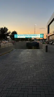 a sign for a parking lot in front of a building at New Modern Apartment Ciudad Gamma Cordoba Luxury in Cordoba