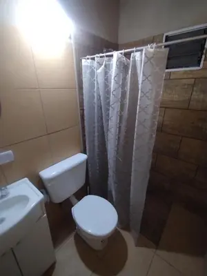 a bathroom with a toilet and a sink and a shower at La Eterna in Villa del Dique
