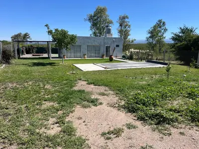 an empty yard with a house in the background at Biale Masse Casa de Montaña in Bialet Massé
