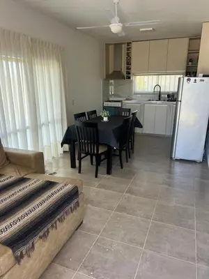 a kitchen and dining room with a table and chairs at Biale Masse Casa de Montaña in Bialet Massé