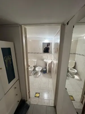 a bathroom with two toilets and a sink at La casa del varón in Mina Clavero